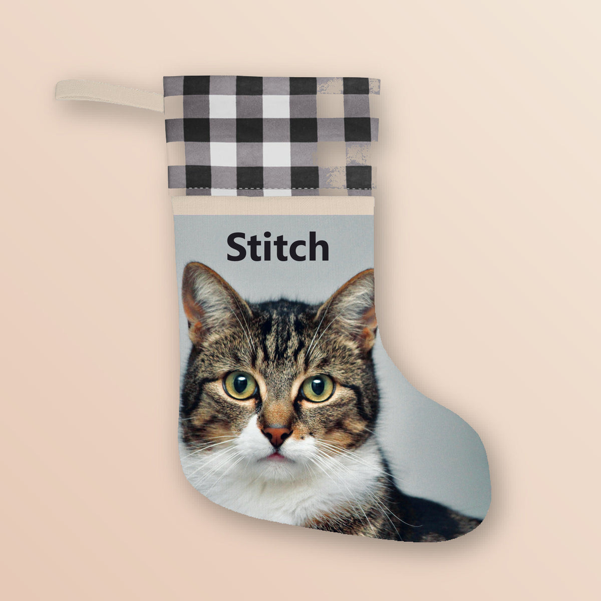 Custom pet photo Christmas stocking with white plaid cuff showing a tabby cat photo and the name Stitch